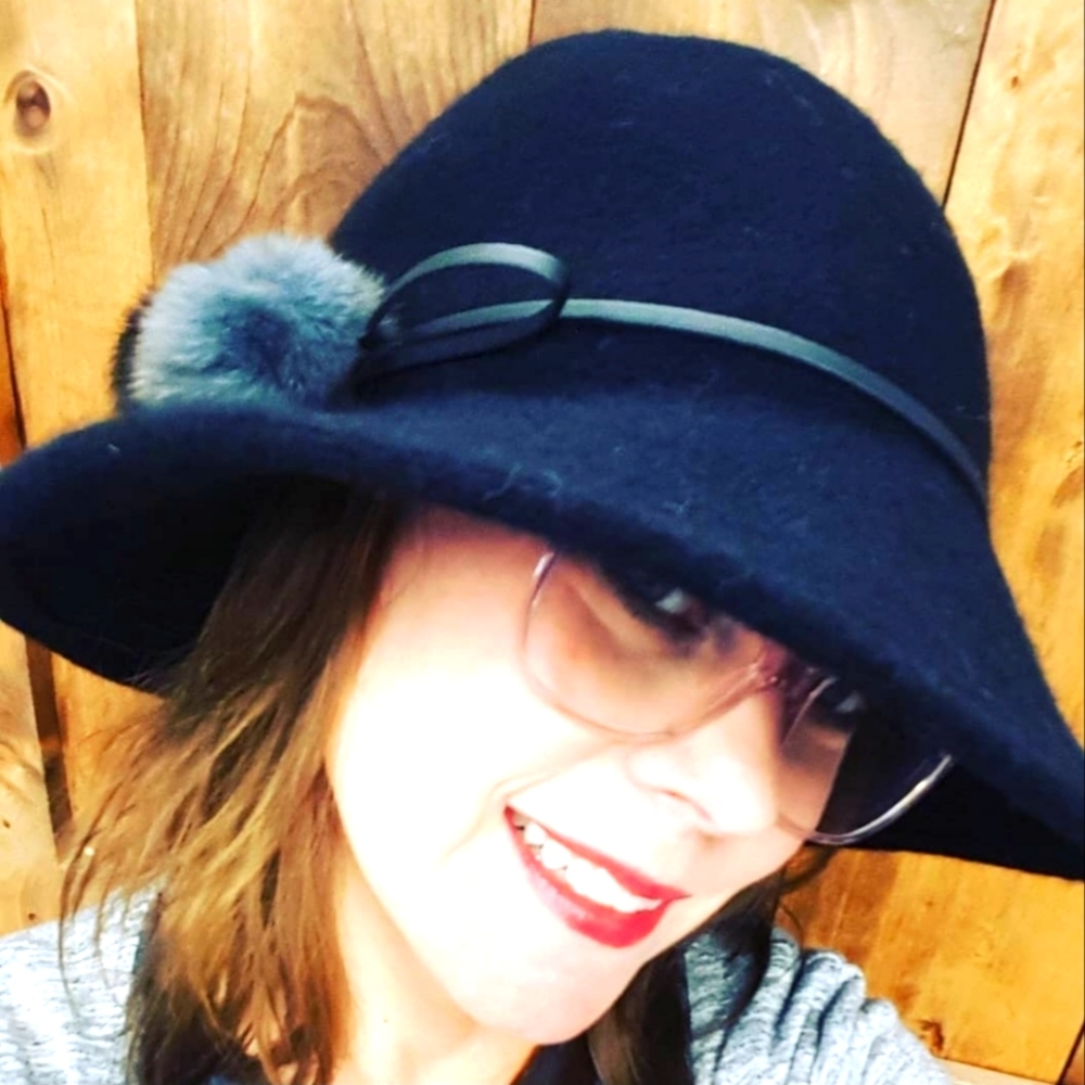 Wool floppy hat with pom poms.